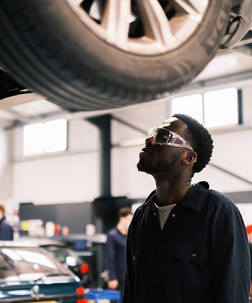 Apprentice looking underneath car