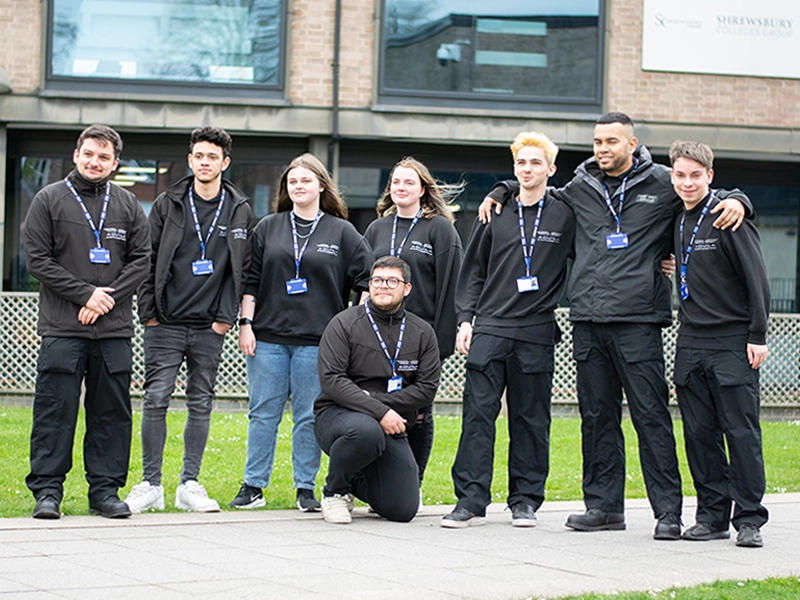 Group of students standing together smiling