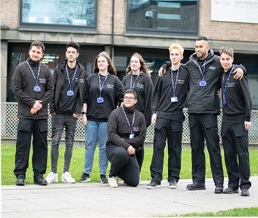 Group of students standing together smiling