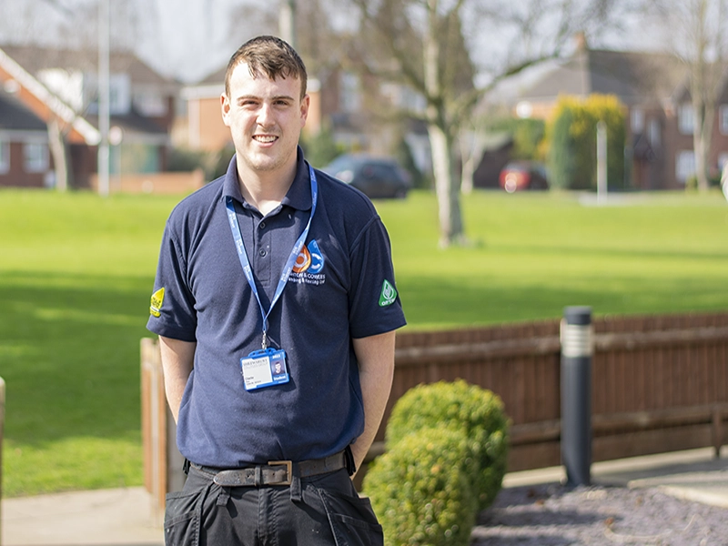 Charlie Oliver standing in uniform outside the college