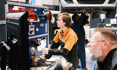 Automotive student using diagnostic equipment 