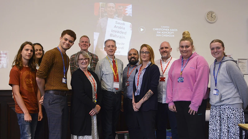 Peter Tatchell standing with a group of college students and members of staff