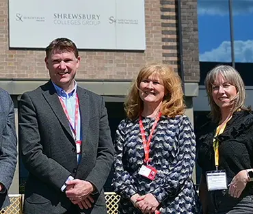 Senior Leadership team with employers at Reech standing outside the front of London Road Campus