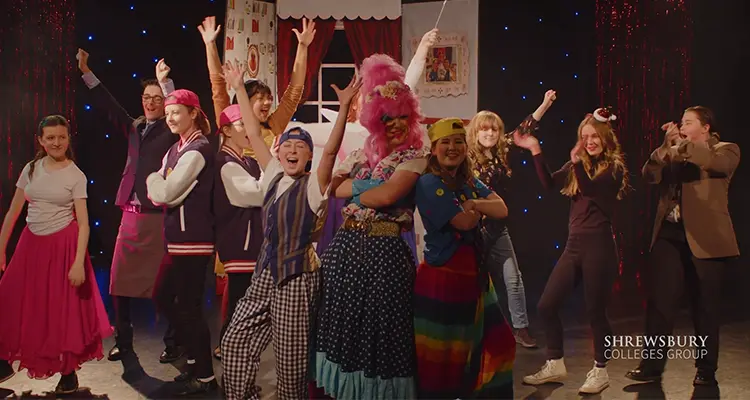 A Group of performing art students, in full costumes performing panto