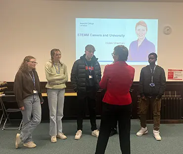 students talking to Helen Sharman in classroom