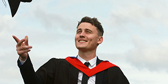 Higher education graduate in a cap and gown