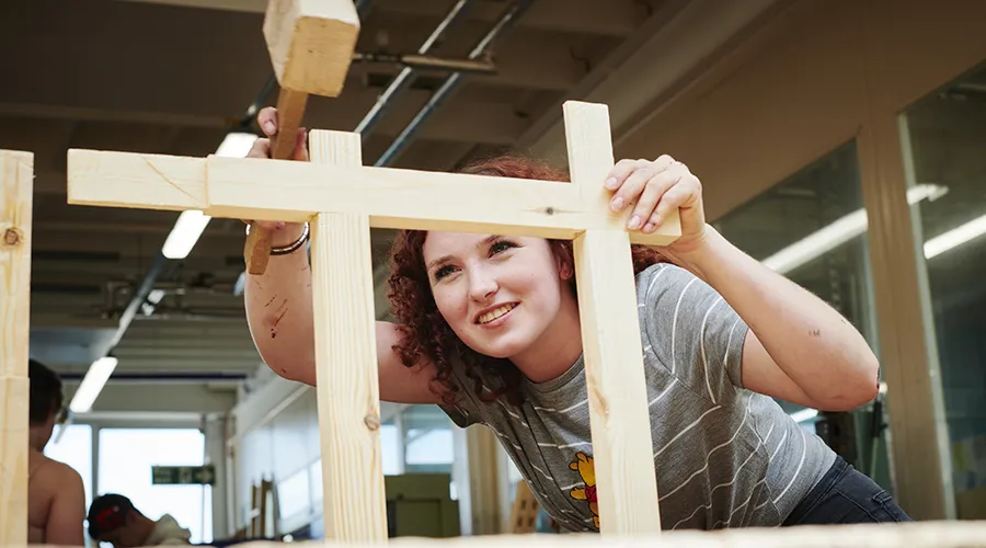 Student securing wooden joint