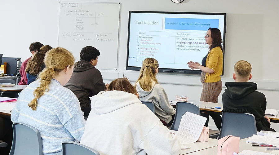 class of students with teacher doing presentation 